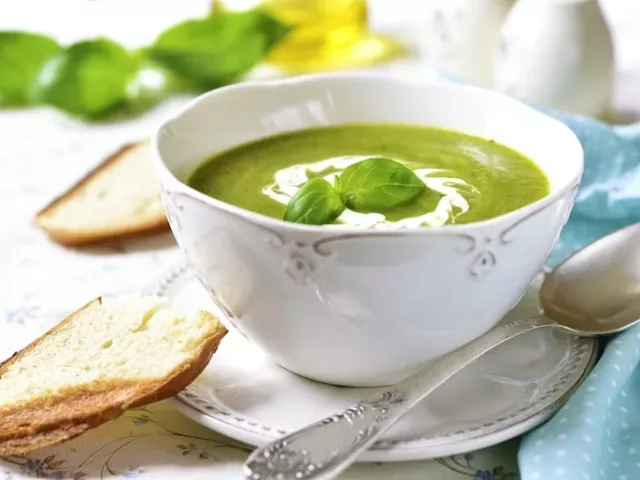 Bowl of avocado gazpacho with green grapes for summer