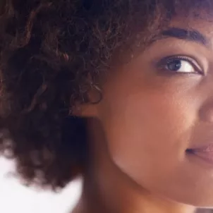 Young woman with natural hair and clean skin free from hyperpigmentation