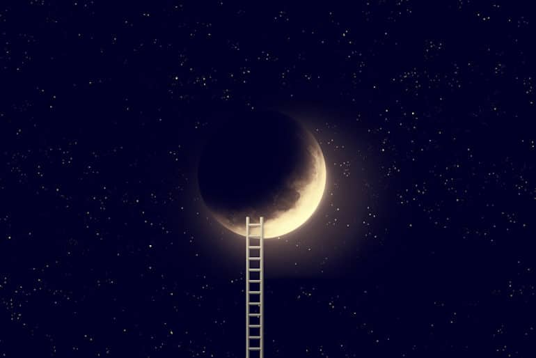 Ladder leading up to crescent moon in night sky