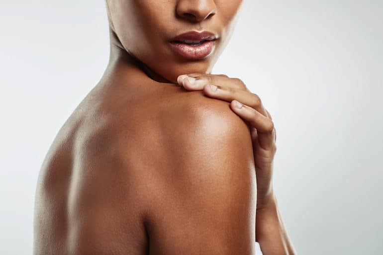 Side shot of a woman with glowing skin and a healthy skin barrier