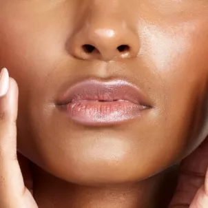 Closeup shot of a beautiful dark-skinned woman with radiant, hydrated skin and a healthy skin barrier