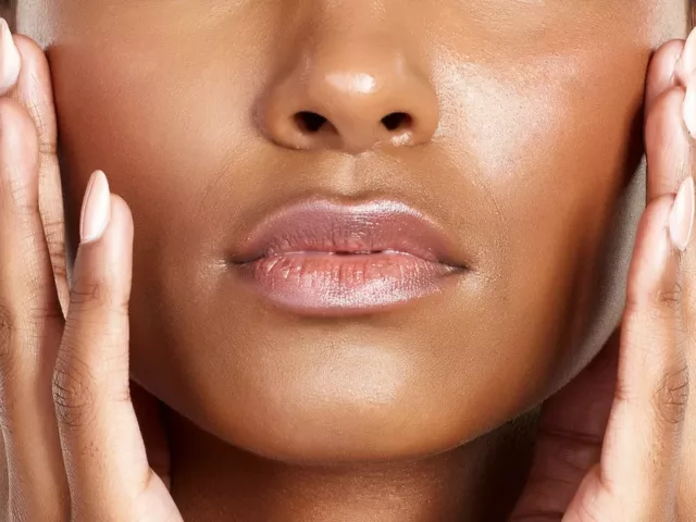 Closeup shot of a beautiful dark-skinned woman with radiant, hydrated skin and a healthy skin barrier