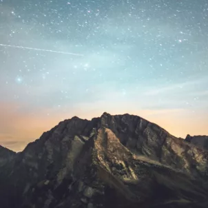Blue and orange starry horizon atop a mountain