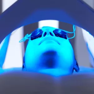 Woman getting LED blue light therapy for acne