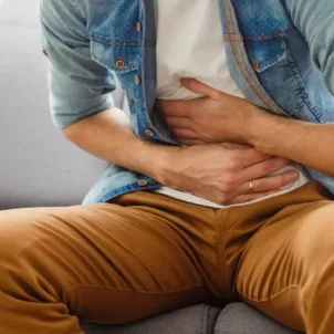 Man feeling leaky gut symptoms