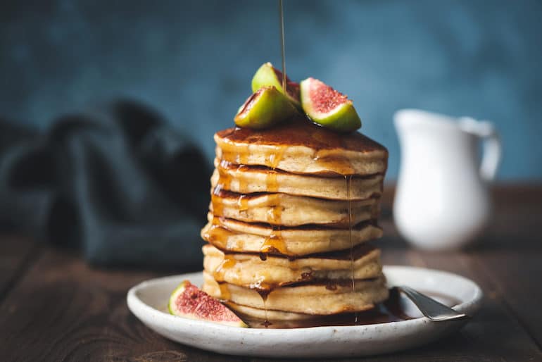 Maple syrup dripping over pancakes