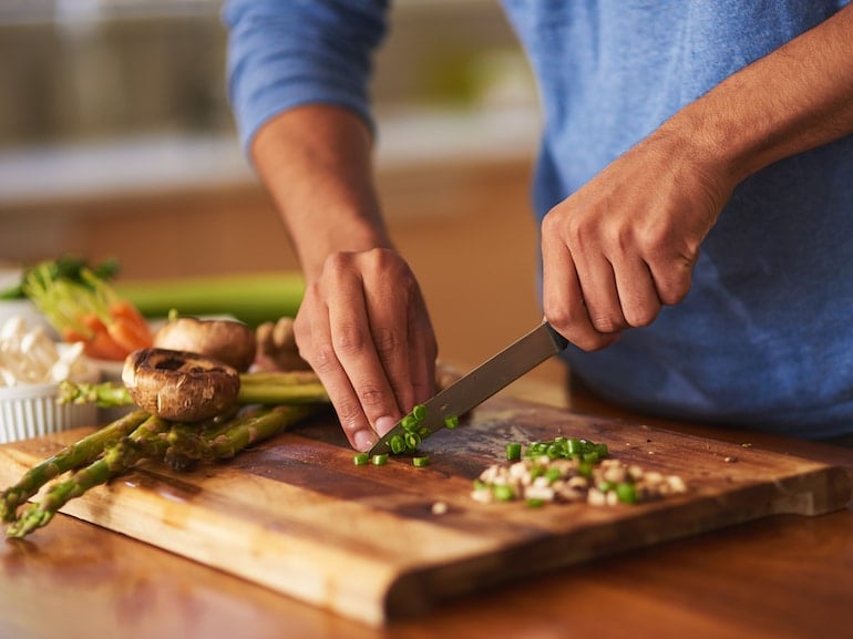 Man cooking at home as new years resolution to cook more