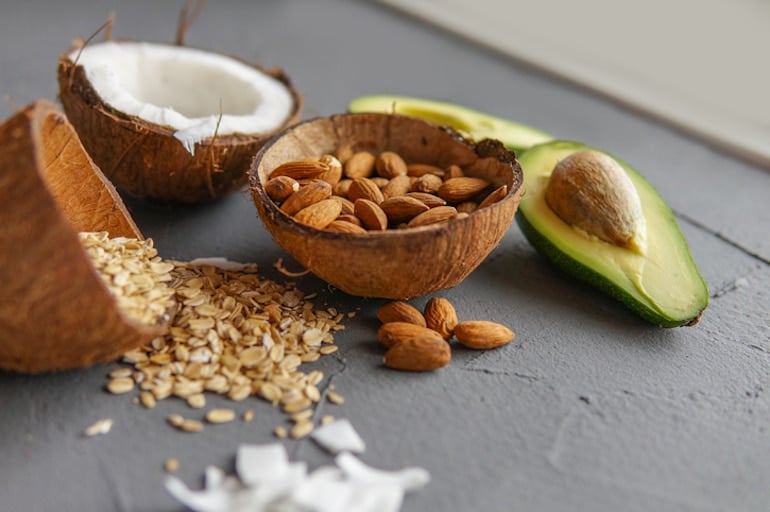 Healthy fats including almonds, avocado, and coconut to help build muscle