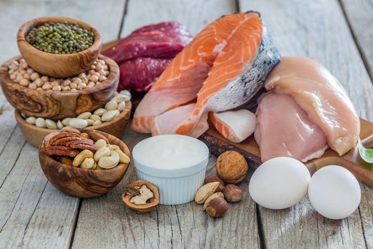 Protein-rich foods to build muscle, including chicken, beef, salmon, and lentils