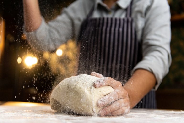 Man preparing dough, which contains gluten and may lead to acne