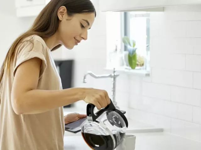 Woman pouring second cup of coffee from pot