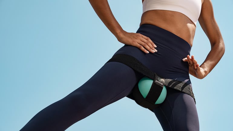 Woman working out using P.volve equipment to target inner thighs