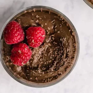 Avocado Chocolate Mousse dessert topped with raspberries