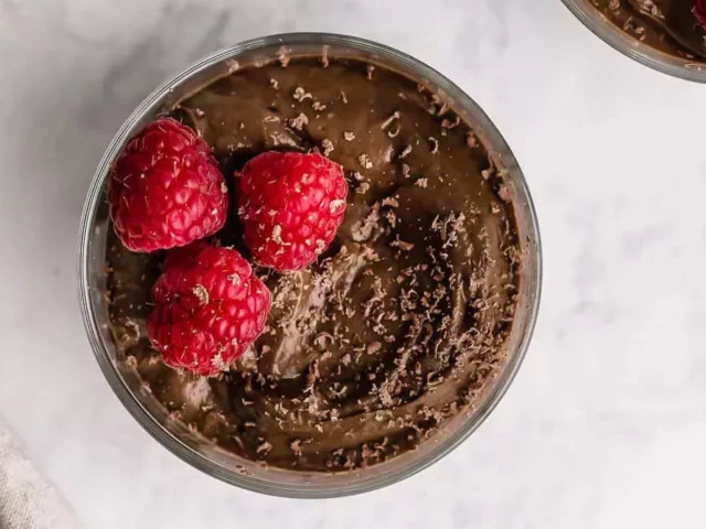 Avocado Chocolate Mousse dessert topped with raspberries