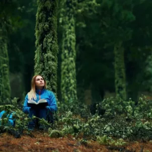 Woman journaling in solitude in forest