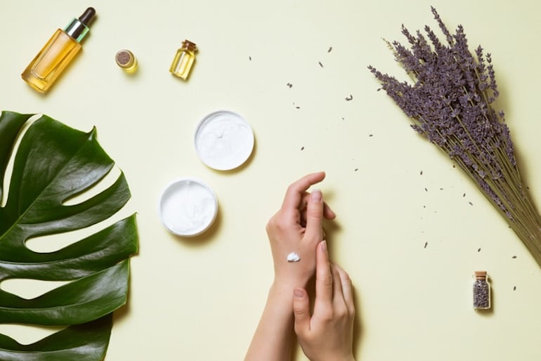 Woman patch testing plant-based skincare products on her hand