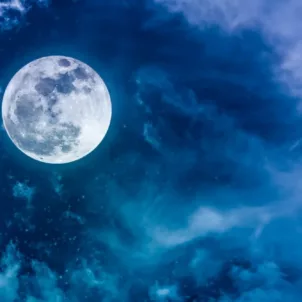 Blue and purple night sky with full moon