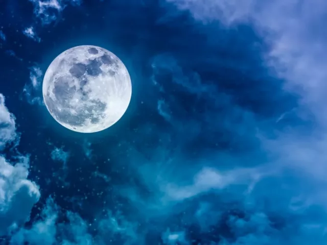 Blue and purple night sky with full moon