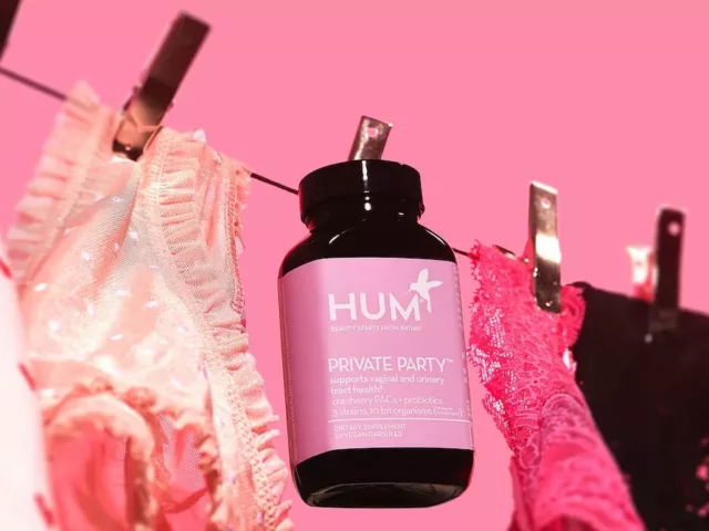 HUM Nutrition Private Party probiotic for vaginal health on clothing line with lingerie over pink background