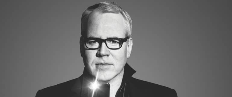 Bret Easton Ellis in black and white with iPhone flash