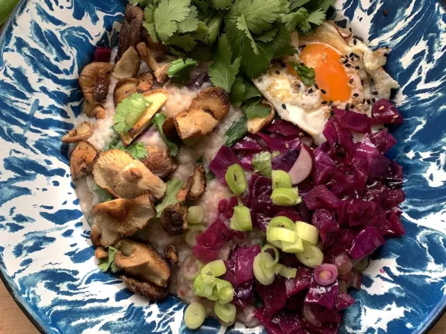 Easy congee recipe dish with mushrooms, green onion, cilantro, and radishes