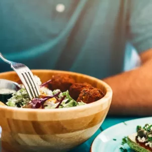 Man eating salad with healthy fats