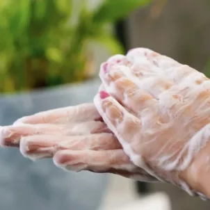 Woman washing her hands with soap