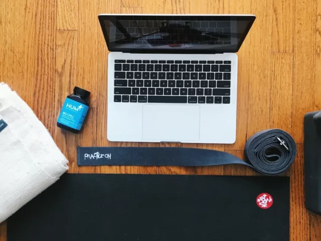 Laptop and yoga mat set-up for online yoga classes