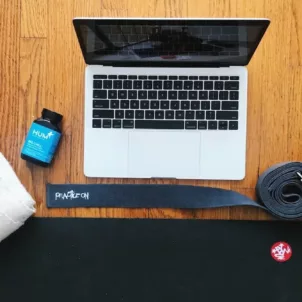 Laptop and yoga mat set-up for online yoga classes