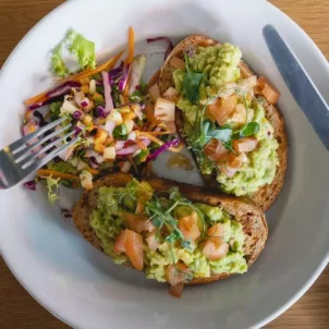 Man cutting into a plant-based diet meal on toast