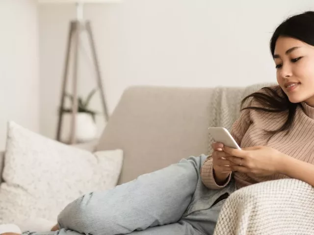 Woman listening to podcasts on her couch