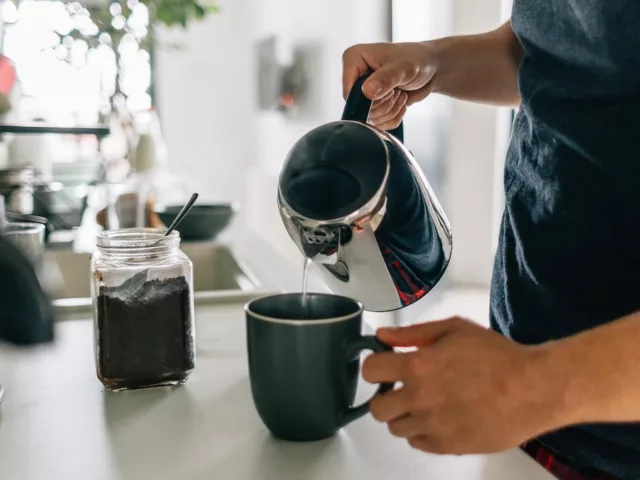 Man pouring coffee at home, but too much caffeine can weaken immune function