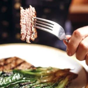 Man eating steak and greens, a great meal for keto for beginners