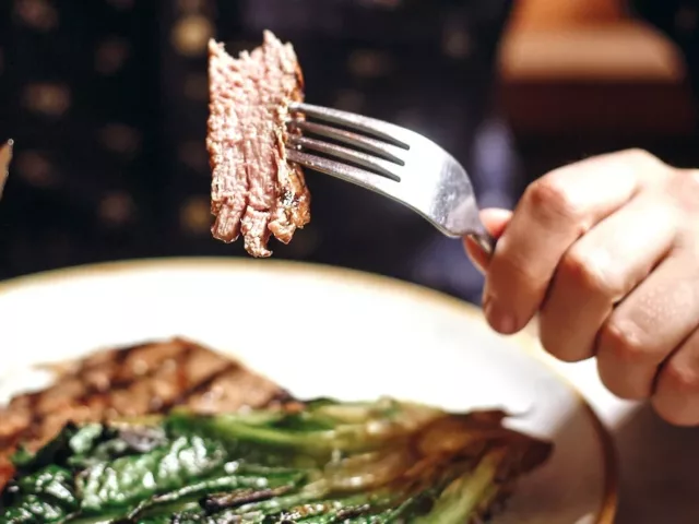 Man eating steak and greens, a great meal for keto for beginners