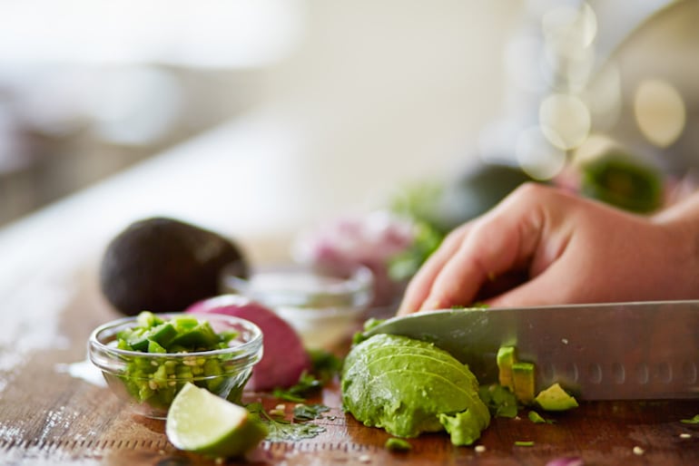 Cutting an avocado to be frozen