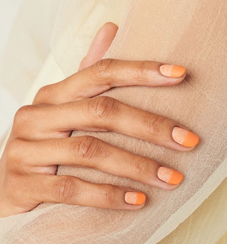 Woman with two-toned orange gel nails