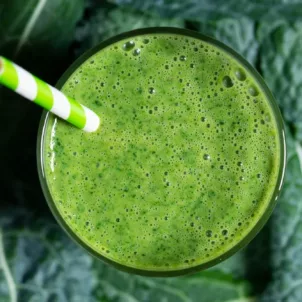 Kale and vitamin C smoothie on a bed of kale leaves