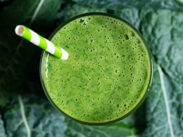 Kale and vitamin C smoothie on a bed of kale leaves