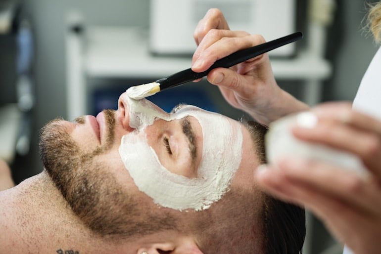 Man with beard getting a facial - more advanced step for skincare for men