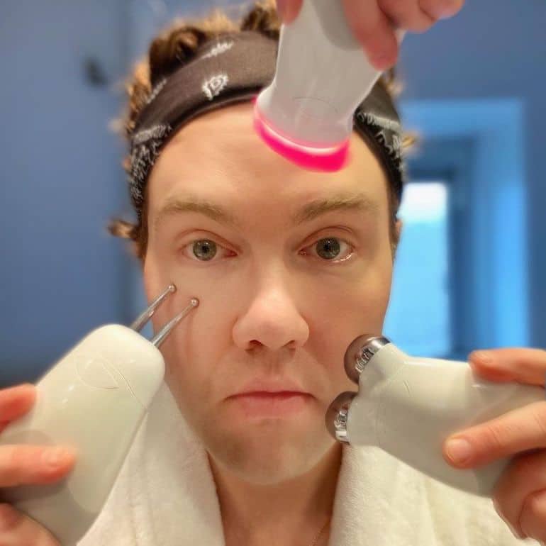 Grooming editor Garrett Munce using three skincare devices