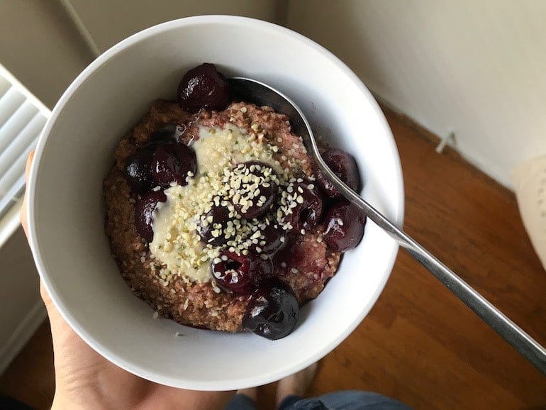 Oats with berries, hemp seeds, cacao, and nut milk for a good WFPB diet breakfast