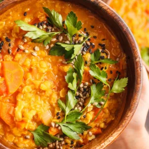 Woman holding WFPB diet meal of vegan curry