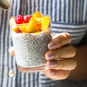 Woman holding chia pudding to boost her energy levels through food