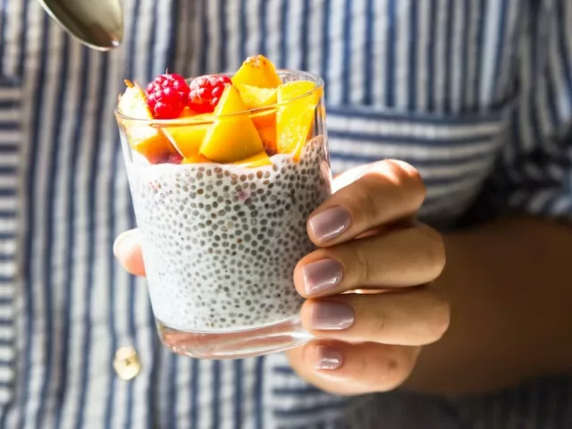 Woman holding chia pudding to boost her energy levels through food