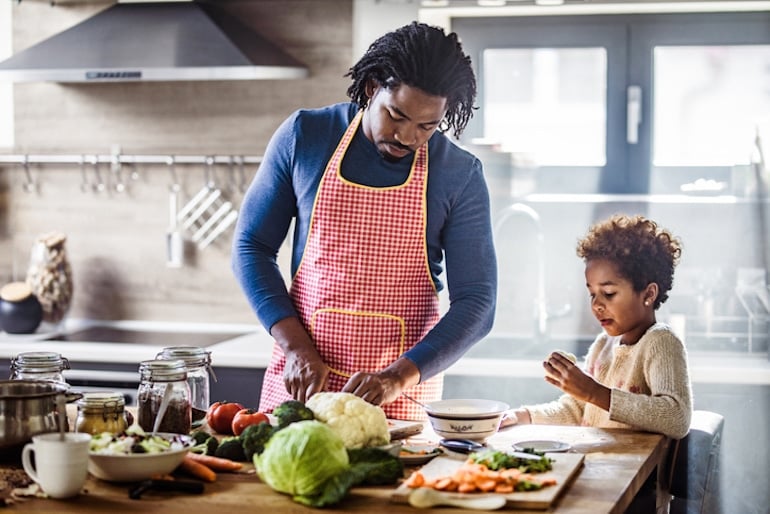 Father and daughter cooking healthy dinner, using broccoli as a food source of chromium