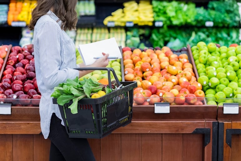 Woman shopping for fresh whole foods as the first step of mindful eating