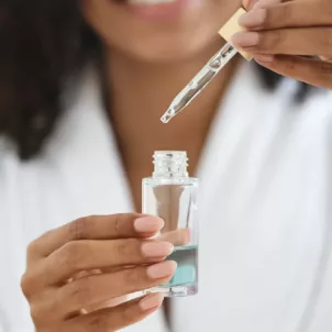 Woman holding a face serum to target her skin concerns