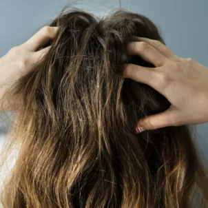 scalp massage benefits woman massaging head