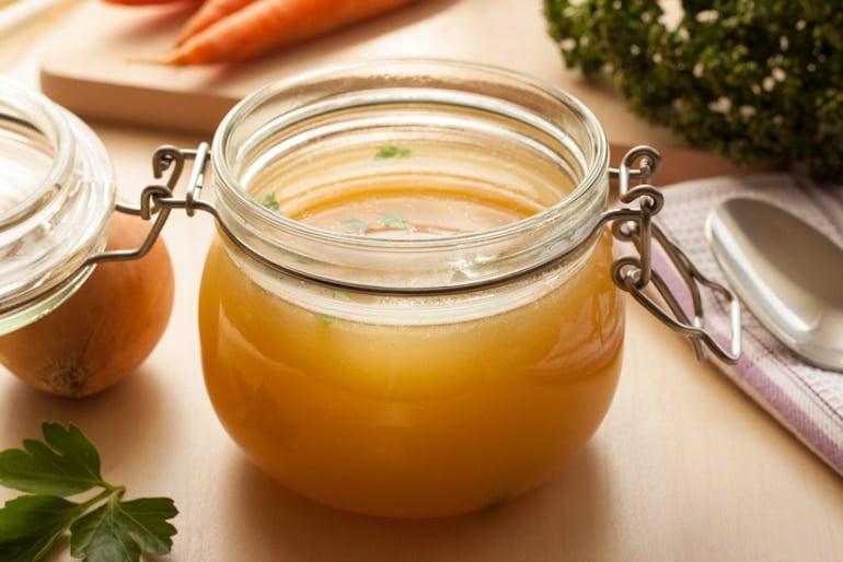 Bone broth made from chicken next to other ingredients, which packs the best food source of hyaluronic acid