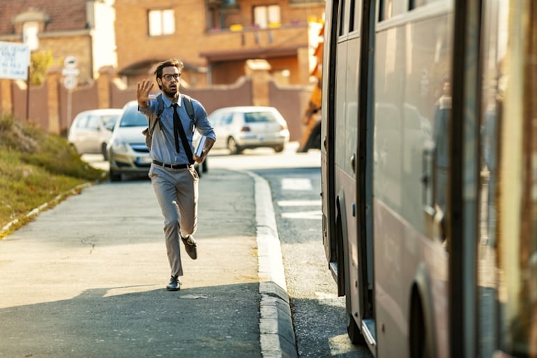 Man chasing a bus, with his cortisol levels spiked due to stress